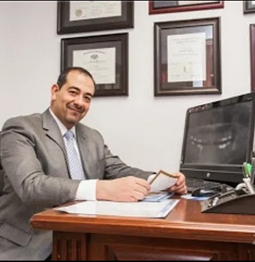 Dr. Rami Rizk at his desk at Allendale Family & Cosmetic Dentistry